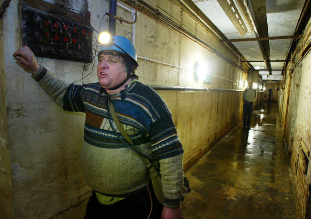 Tourists walking through the damp hallways of the Cabinet War Rooms