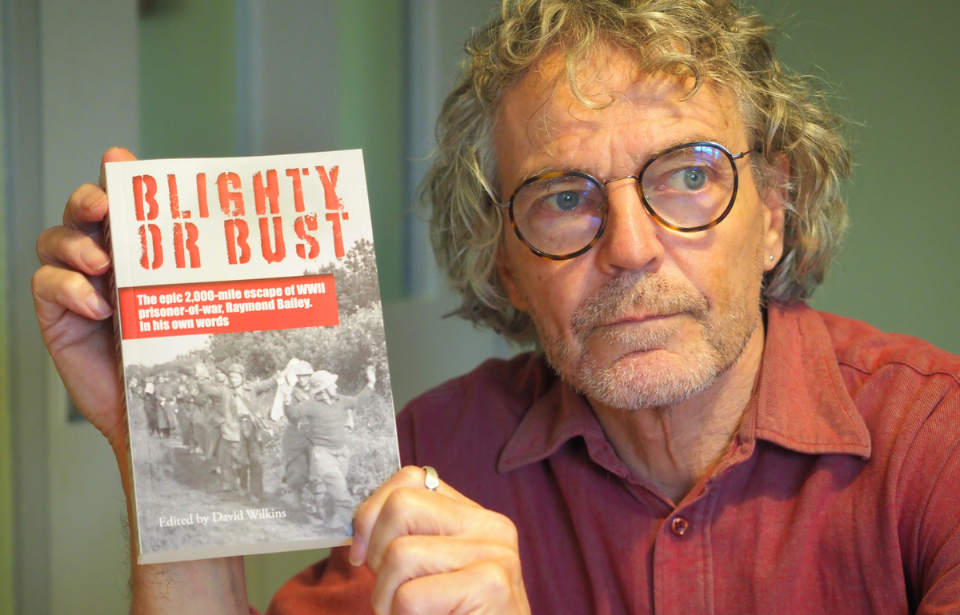 David Wilkins holding a copy of 'Blighty or Bust'