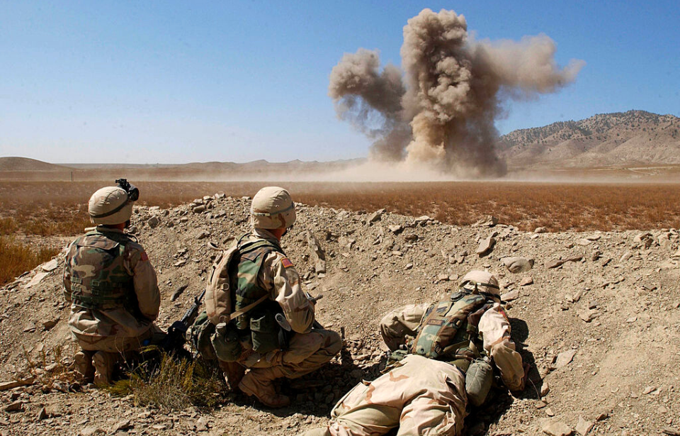 Members of the 82nd Airborne Division watch as a test firing of C4 explosives explodes near the Orgun-e forward base in Afghanistan. The explosion was part of training exercises to teach U.S. troops how to build field explosives out of explosive C4 and detonation cords.