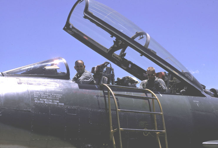 Two Misty unit members sitting in the cockpit of an F-100F Super Sabre