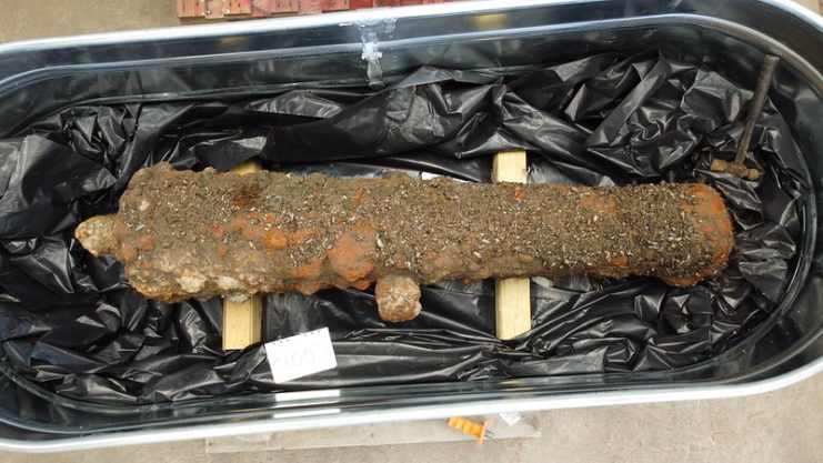 Overhead view of a Revolutionary War-era cannon in a metal bucket