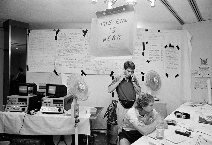 Two CNN journalists in a small room