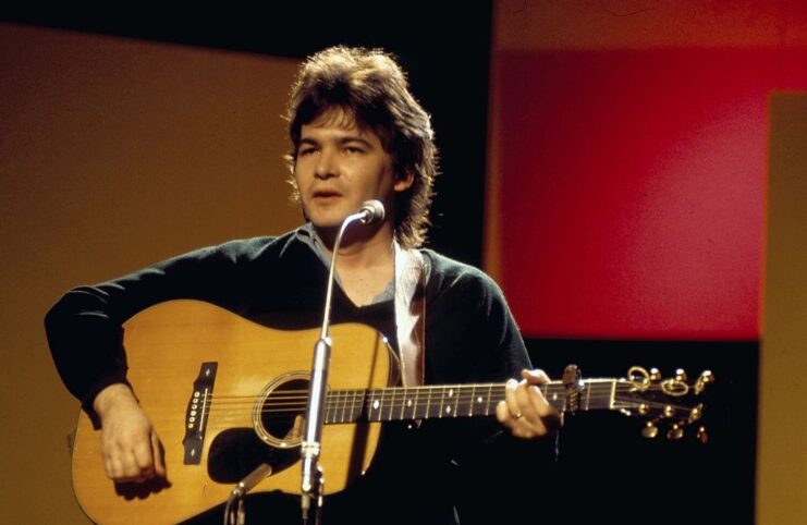 John Prine performing on stage