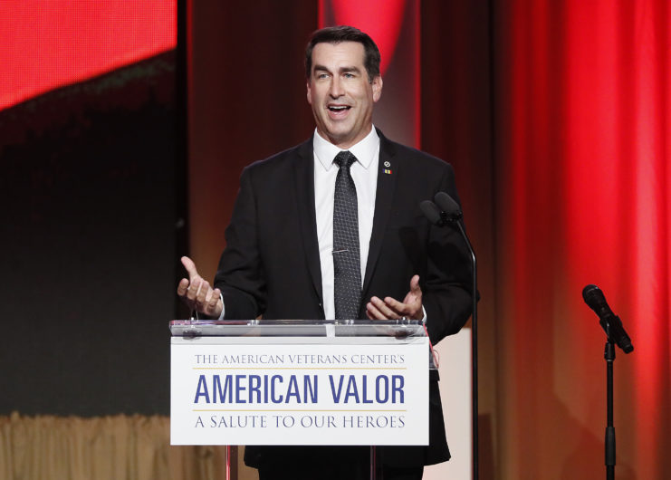 Rob Riggle speaking at a podium