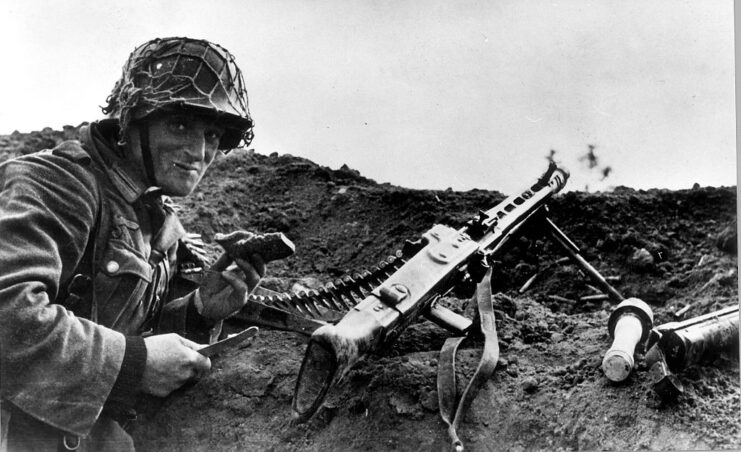 German machine gunner standing beside his MG 42