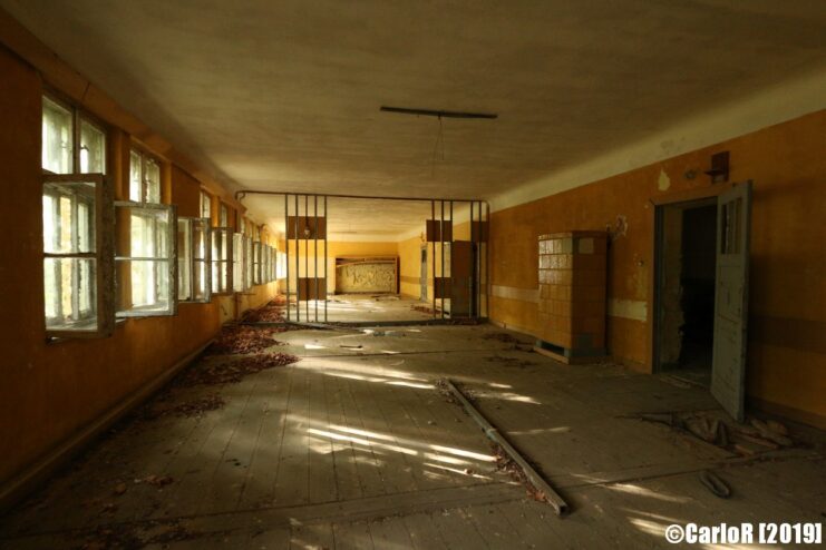 View of a gate down a long and dim hallway