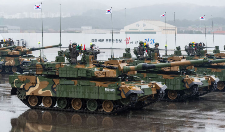 K2 Black Panthers driving down a road on a rainy day