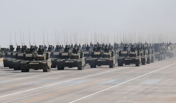 Type 99A main battle tanks (MBTs) driving down a wide road