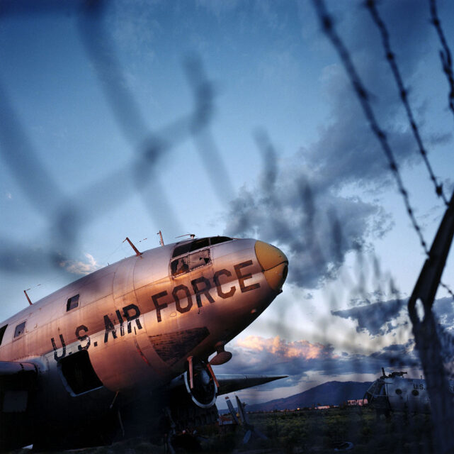 Curtiss C-46 Commando parked near a fence