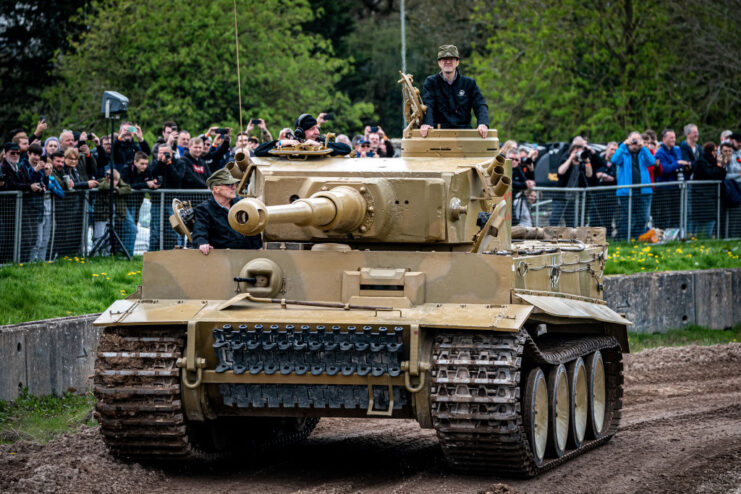 Spectators watching Tiger 131 drive around a dirt track