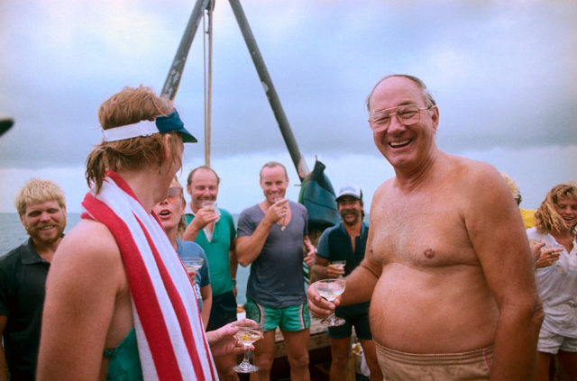 Divers holding glasses of champagne