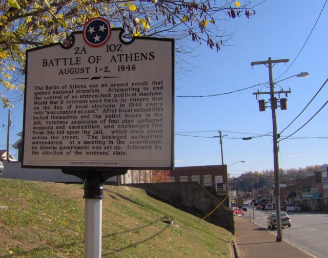 Colored photo of a street marker for the Battle of Athens.